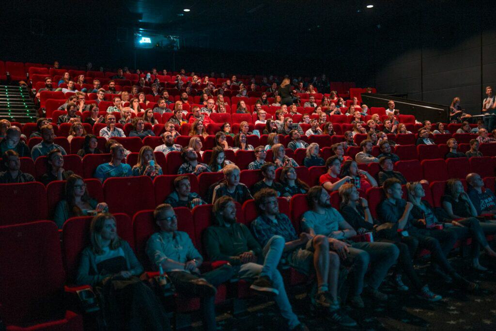 person watching movie screenx movie theater