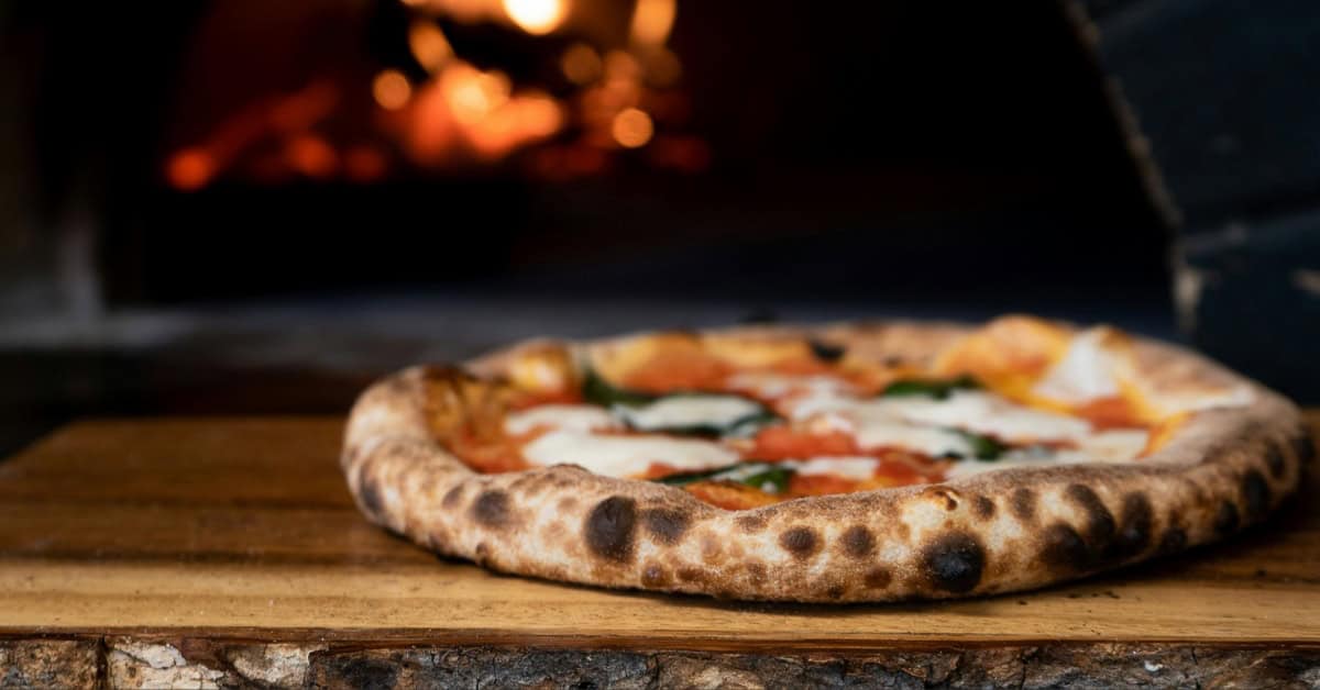 A pizza bubbling in the oven.