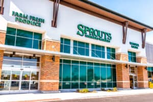 Exterior of Sprouts Farmers Market store with farm fresh produce sign on street