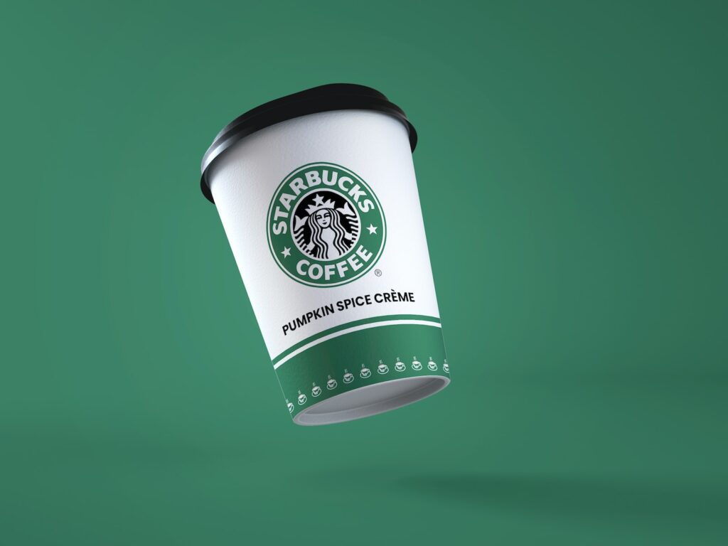 a starbucks coffee cup flying through the air