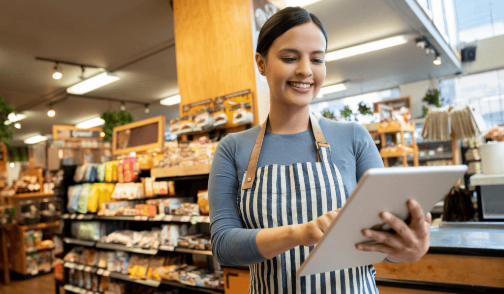 Supermarket worker with tablet